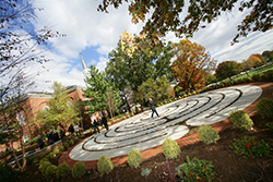 Image of the labyrinth in autumn as the leaves of the trees are just starting to turn gold and red